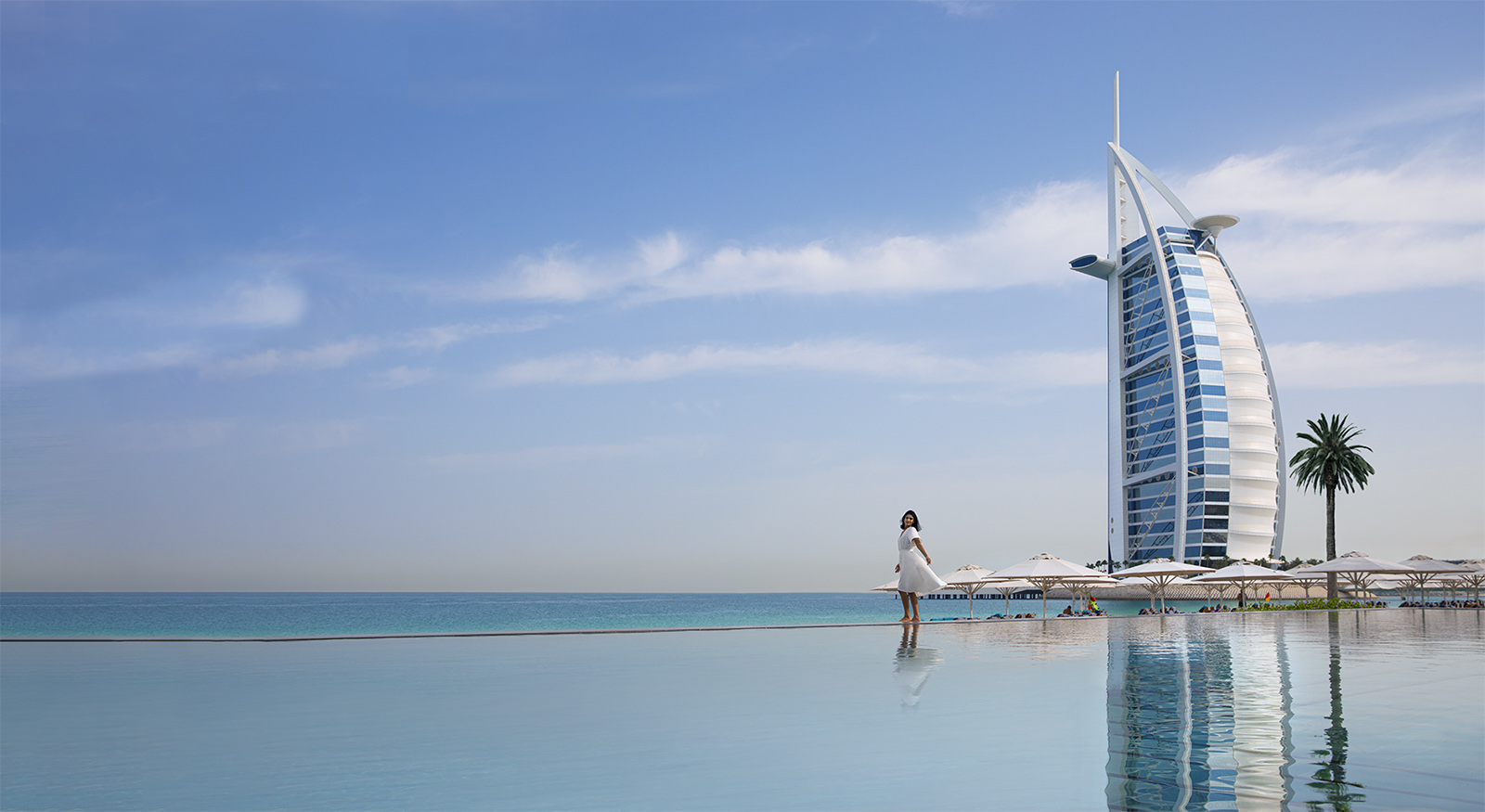Woman standing infront of Burj Al Arab in Dubai